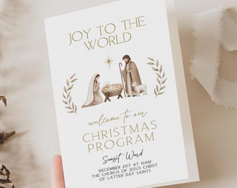 May include: A folded Christmas program with the text "JOY TO THE WORLD" in gold lettering. The program features an illustration of the Nativity scene and the text "welcome to our CHRISTMAS PROGRAM".