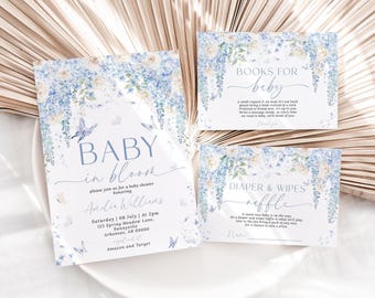 Op de afbeelding: Babyshower briefpapier set met een bloemenontwerp in blauw en wit. De uitnodiging luidt "Baby in Bloom" en bevat details van het evenement. Extra kaarten zijn onder meer "Books for baby" en "Diaper & Wipes raffle".