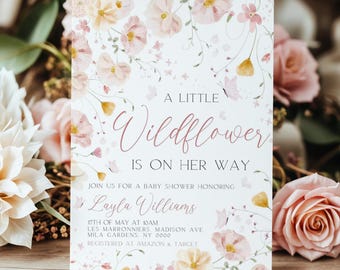 May include: A baby shower invitation with a floral design. The text reads "A Little Wildflower is on her way." The invitation includes the date, time, and location of the shower, as well as the name of the guest of honor, Layla Williams. It also includes the information that the guest of honor is registered at Amazon and Target.
