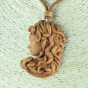 Hand Carved Wood Medusa Necklace on Adjustable Cord with Ceramic Bead