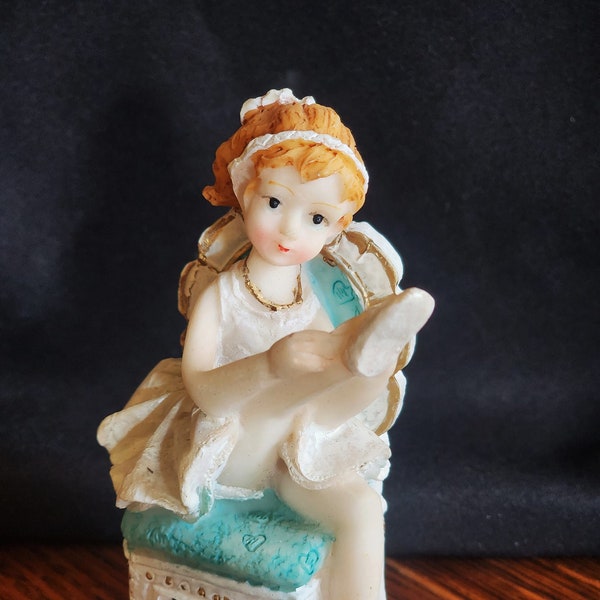 Vintage Resin Ballerina Seated in Chair Leg Up