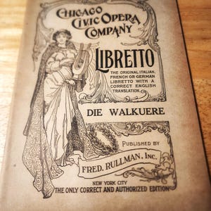 May include: A vintage tan paper libretto for the Chicago Civic Opera Company production of Die Walkuere. The cover features a black ink illustration of a figure holding a lyre, ornate scrollwork borders, and text including Price 30 Cents.