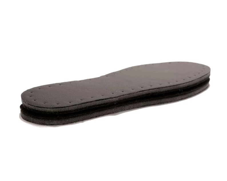 May include: A black leather insole with a layer of foam padding. The insole has a stitched edge and a textured surface.