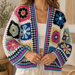 May include: A long-sleeve open-front cardigan constructed from multi-colored crochet granny squares. The garment features a vibrant floral pattern in shades of hot pink, bright blue, yellow, black, and white, with a straight hem and wide sleeves.