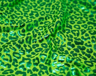May include: Green fabric with a metallic green leopard print pattern.