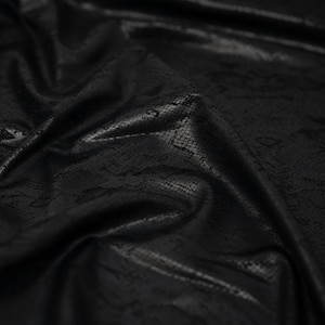 May include: Black faux leather fabric with a snakeskin pattern.