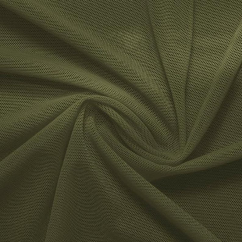 May include: A close-up of a piece of olive green mesh fabric. The fabric has a fine, even weave and is slightly wrinkled.