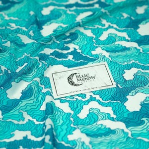 A sample of Crazy Waves Printed Power Mesh with Blue Moon Fabrics logo