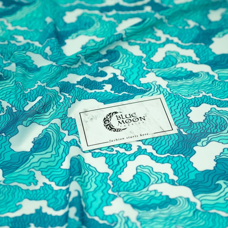 A sample of Crazy Waves Printed Power Mesh with Blue Moon Fabrics logo