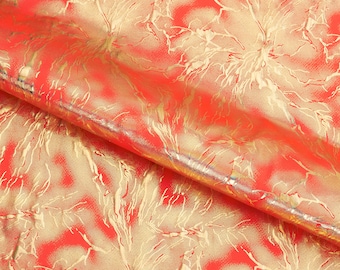 May include: Red fabric with a gold metallic pattern of swirling branches. The fabric is textured and has a slight sheen.