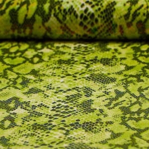 May include: Green fabric with a snakeskin pattern. The fabric has a light green background with a darker green snakeskin pattern.