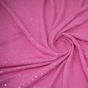 May include: Pink fabric with silver glitter throughout. The fabric is soft and has a subtle sheen.