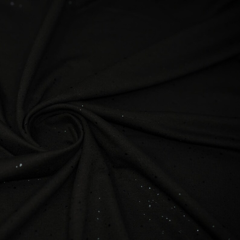 May include: Black fabric with a subtle sparkle. The fabric is soft and has a slight sheen.