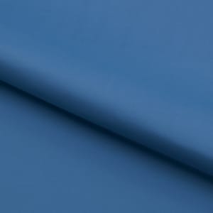 May include: A close-up of a smooth, solid blue fabric. The fabric is folded in half, creating a diagonal line across the image.