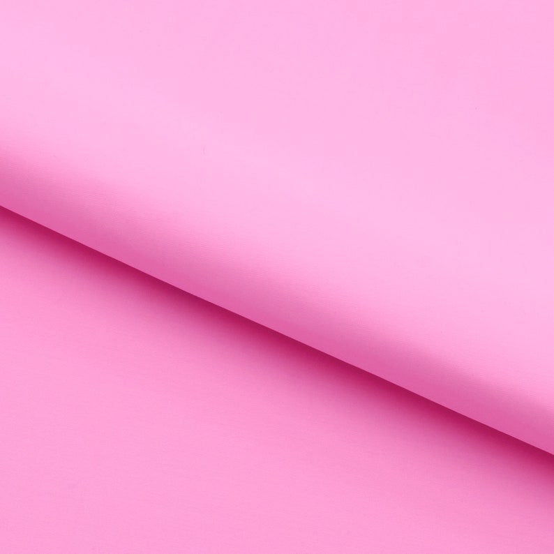 Pu&ograve; includere: Un foglio di carta rosa pieno piegato a met&agrave;, creando una piega diagonale.