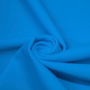 May include: A close-up of a bright blue fabric, showing the texture and drape of the material.
