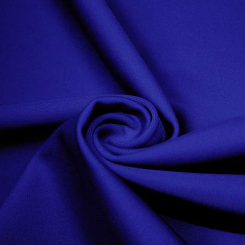 May include: A close-up of a royal blue fabric, folded and draped to show its texture and drape.