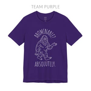 Abominable? Absolutely Yeti Tee | Funny Bigfoot Shirt | Cryptid Top | Unisex Jersey Tee Team Purple