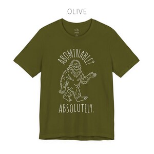 Abominable? Absolutely Yeti Tee | Funny Bigfoot Shirt | Cryptid Top | Unisex Jersey Tee Olive