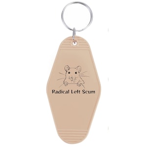 May include: A beige motel-style keychain with a silver ring. The keychain features a black illustration of a mouse and the text "Radical Left Scum" in black.