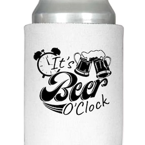 May include: A white beer can cooler with a black graphic design. The design includes an alarm clock, two beer mugs, and the words "It's Beer O'Clock" in a stylized font. The top of the can is silver.