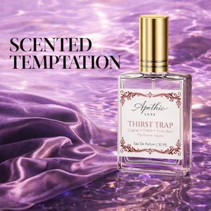 May include: A clear glass perfume bottle with a gold cap, labeled "Apothic Luxe THIRST TRAP". The bottle is set against a purple background with the words "SCENTED TEMPTATION" in the upper left corner. The bottle contains 30 ML of perfume.