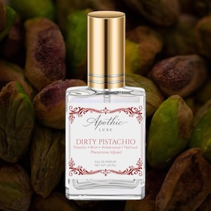May include: Apothecary perfume bottle with a gold cap, labeled "Dirty Pistachio." The label lists pistachio, birch, amberwood, and patchouli as ingredients. The background features pistachios.