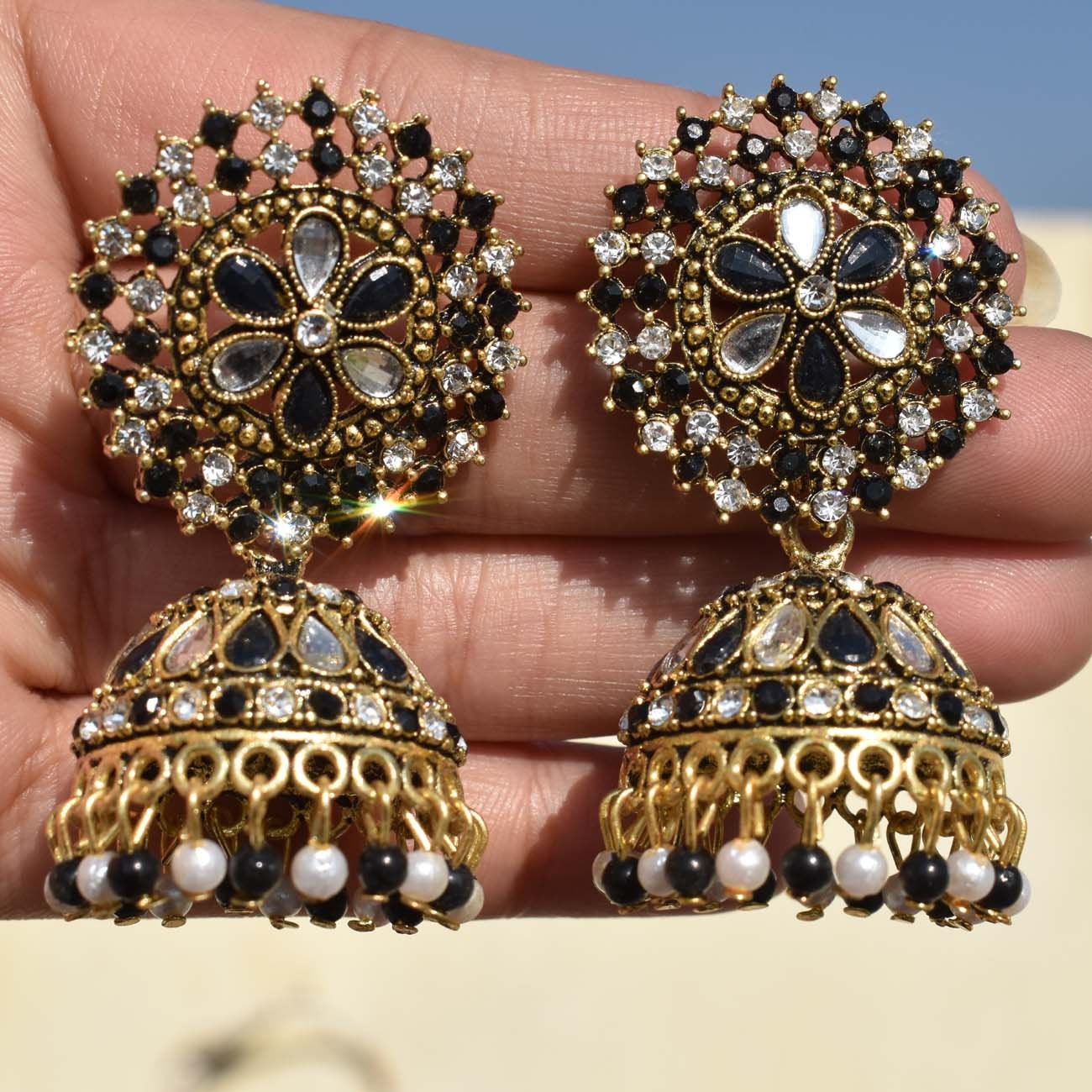 Black stone gold sale jhumkas