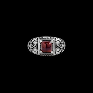 May include: A silver ring with an ornate design and a red gemstone in the center.