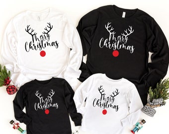May include: Four long-sleeved shirts with a reindeer design and the text "Merry Christmas". Two shirts are white and two shirts are black.