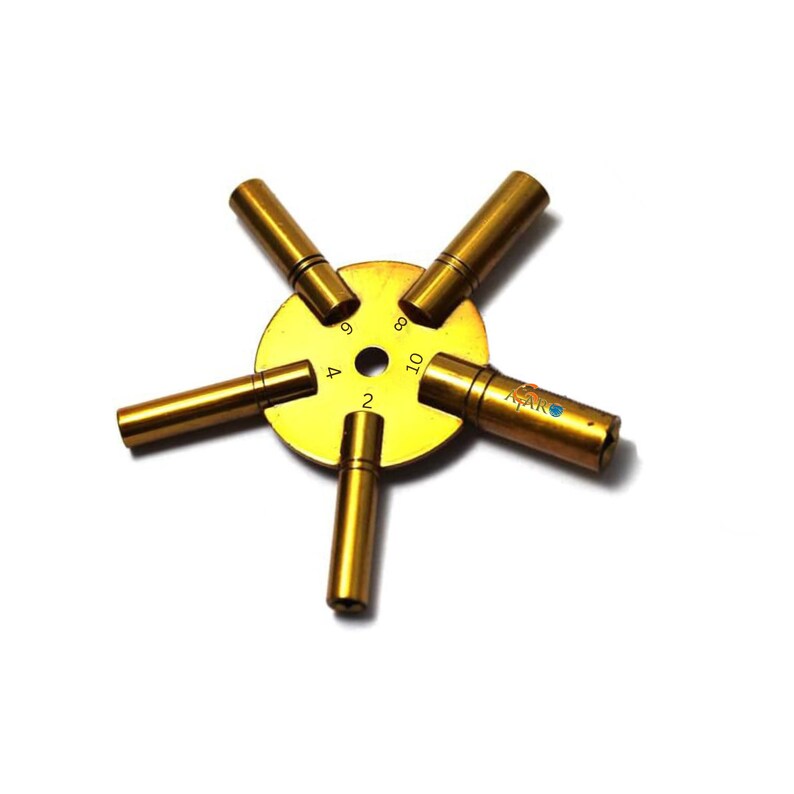 May include: A gold-colored watch key winding tool with five different sized prongs. The prongs are labeled with the numbers 2, 4, 6, 8, and 10.