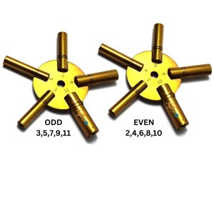 May include: A gold-colored tool with a circular base and five arms. The base has numbers 1-11 printed on it. The arms are labeled "ODD 3,5,7,9,11" and "EVEN 2,4,6,8,10".