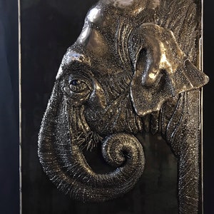 Chewing contemplation.Modern wall bas-relief of an elephant, made of metal by electric welding