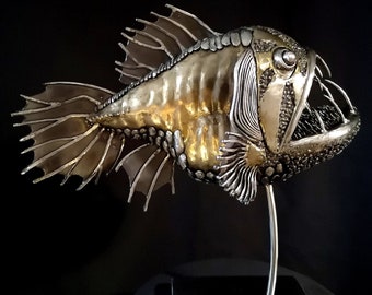 GOLD FISH.Tabletop sculpture of a deep-sea predatory fish made of metal by electric welding