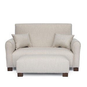May include: A beige loveseat with a high back, rounded armrests, and two matching square throw pillows. The loveseat is paired with a rectangular ottoman featuring the same beige fabric and dark brown block feet, creating a cohesive set.