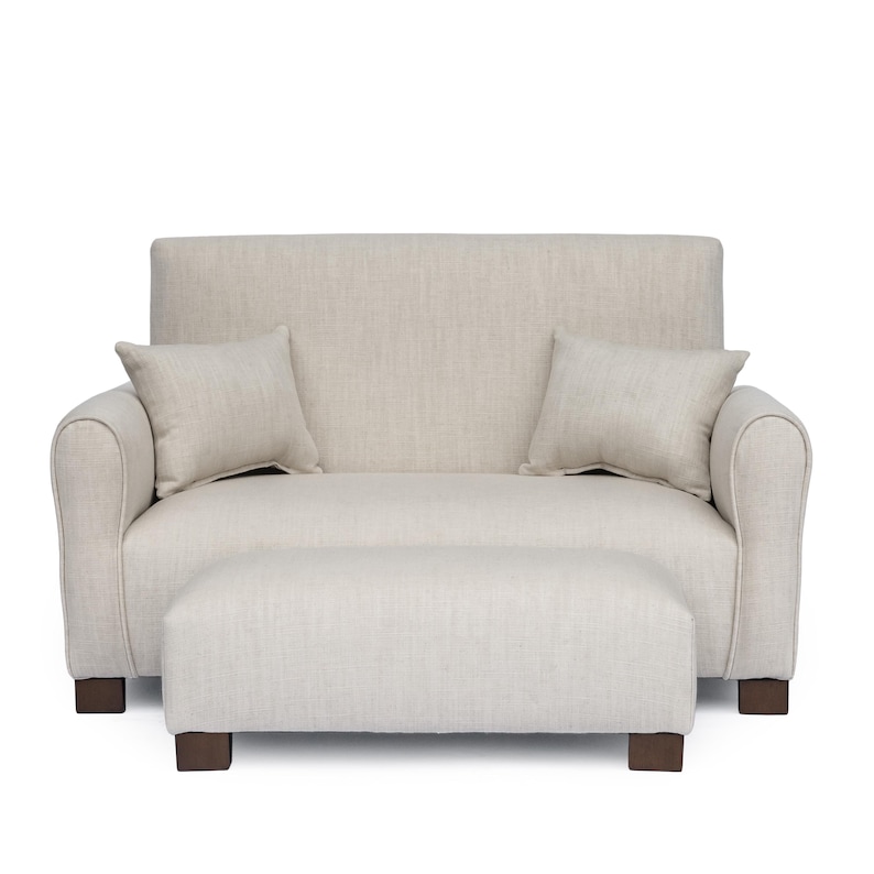 May include: A beige loveseat with a high back, rounded armrests, and two matching square throw pillows. The loveseat is paired with a rectangular ottoman featuring the same beige fabric and dark brown block feet, creating a cohesive set.