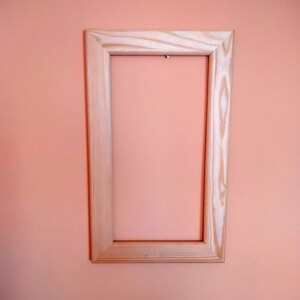 Old open unvarnished light wood picture frame, Rustic picture frame.