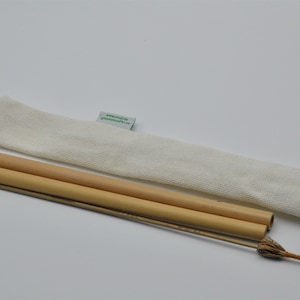 May include: Two natural bamboo drinking straws with a white cotton carrying case. The straws are bundled together and have a small brush for cleaning.