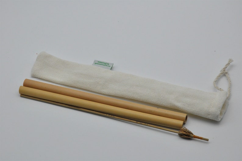 May include: Two natural bamboo drinking straws with a white cotton carrying case. The straws are bundled together and have a small brush for cleaning.