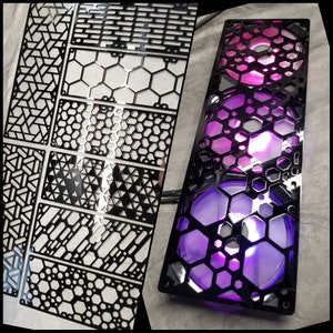 May include: Black computer case with a geometric design and purple LED lights. The case has a honeycomb pattern and is rectangular. Several black metal panels with various geometric cutouts are also visible.