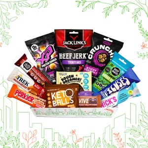 May include: A white rectangular tray filled with various snack foods, including protein bars, beef jerky, and protein balls. The packaging features a range of colours, including red, black, orange, and blue. The tray has a cityscape design.