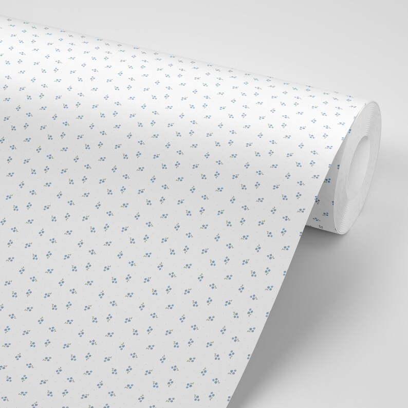 May include: A roll of white wallpaper with a repeating pattern of small blue flowers.