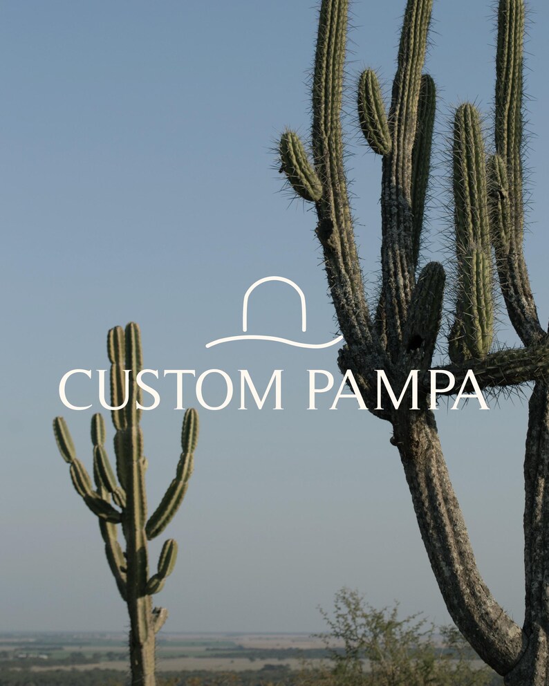 May include: A close-up of two tall cacti against a blue sky. The cacti are green and brown with sharp spines. The text "CUSTOM PAMPA" is written in white letters below the cacti.