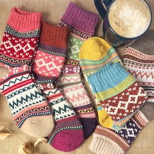 May include: A set of six colorful knitted socks with a geometric pattern. The socks are made of wool and have a warm, cozy feel. They are perfect for keeping your feet warm during the cold winter months.