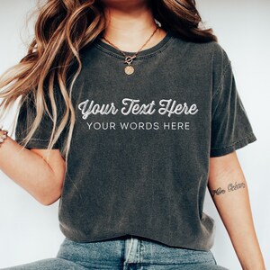 May include: A dark gray t-shirt with a white graphic that says "Your Text Here" and "Your Words Here". The shirt is being worn by a person with long brown hair.