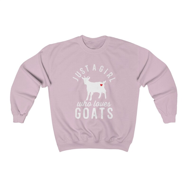 May include: A light pink sweatshirt with a white silhouette of a goat with a red heart on its side. The text "Just a girl who loves goats" is printed on the sweatshirt.