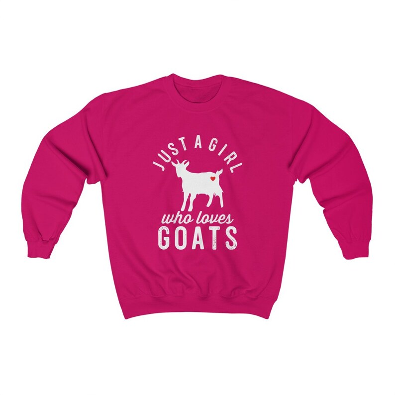 May include: A pink sweatshirt with the text "Just a girl who loves goats" in white. A white silhouette of a goat with a red heart is in the center of the text.