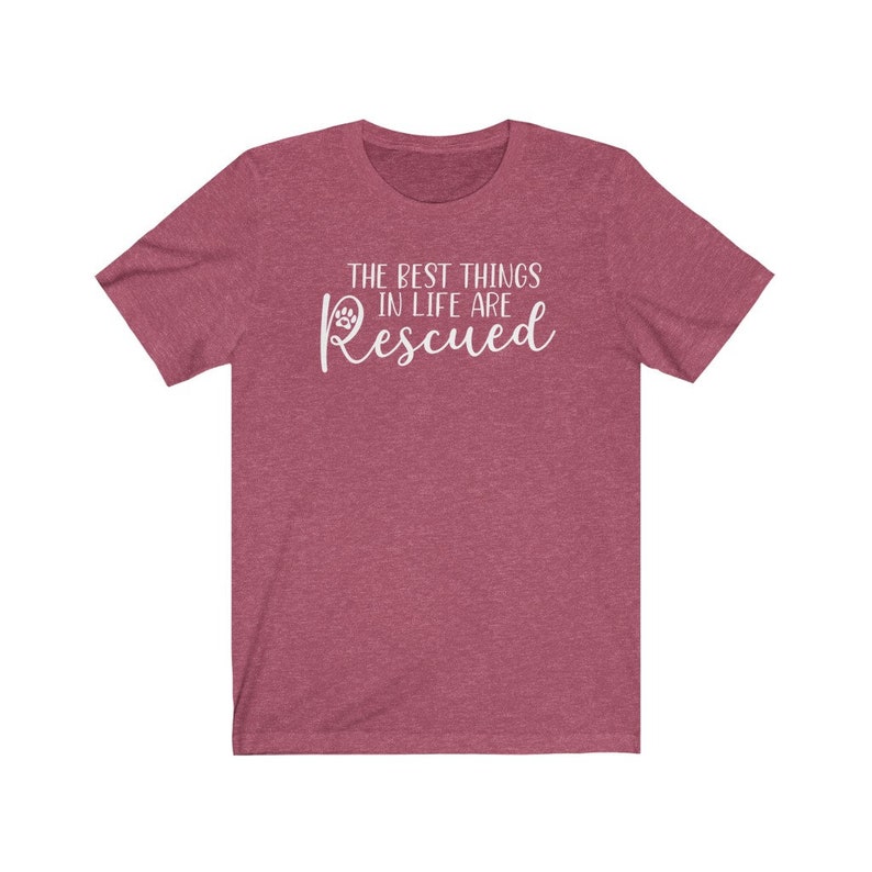 May include: A heather red t-shirt with a white paw print and the text "The best things in life are Rescued".
