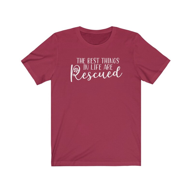 May include: A maroon t-shirt with white text that reads "The best things in life are Rescued" with a paw print symbol.