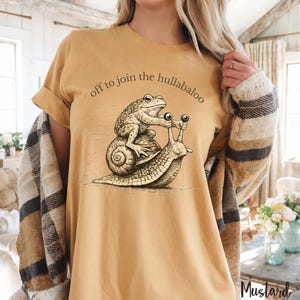 Nyckfull groda och snigel-t-shirt, iväg för att gå med i all oväsen, rolig djurt-t-shirt från Cottagecore, vintage etsad groda-tröja, mysig kaospresent Mustard